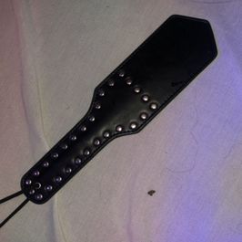 1 black leather studded paddle