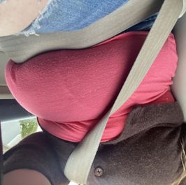 My chubby belly hanging over my seatbelt