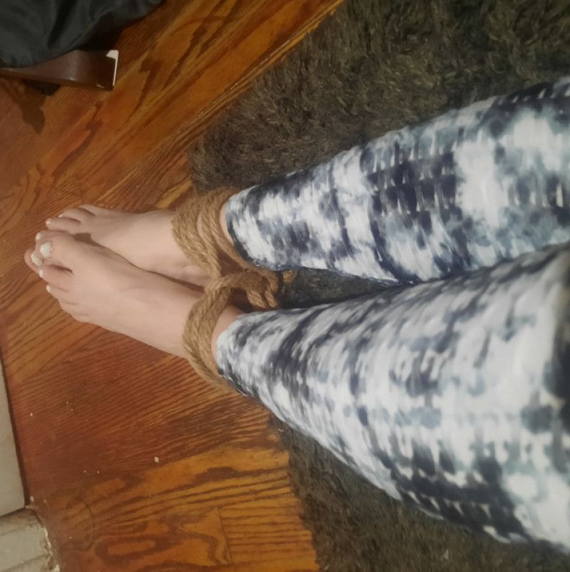 Tied barefeet wearing leggings