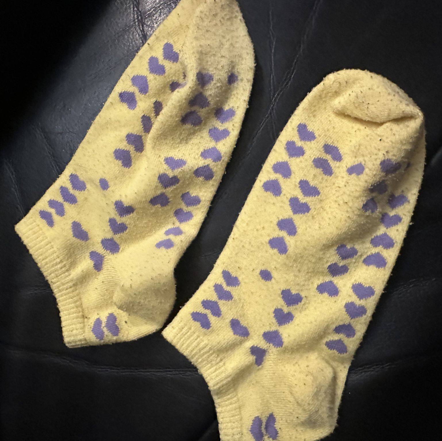 Worn yellow purple heart socks