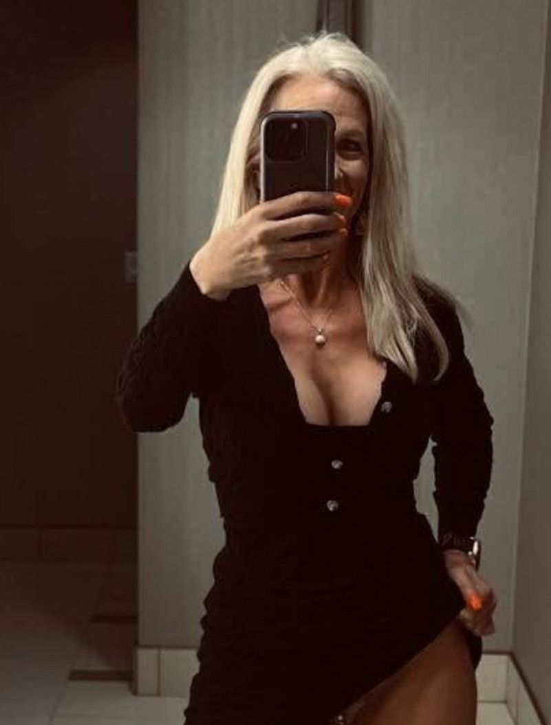 Black sweater dress showing off cleavage