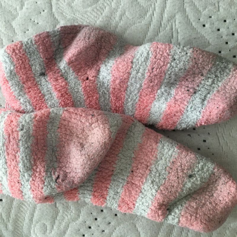 Well worn pink white fuzzy striped socks