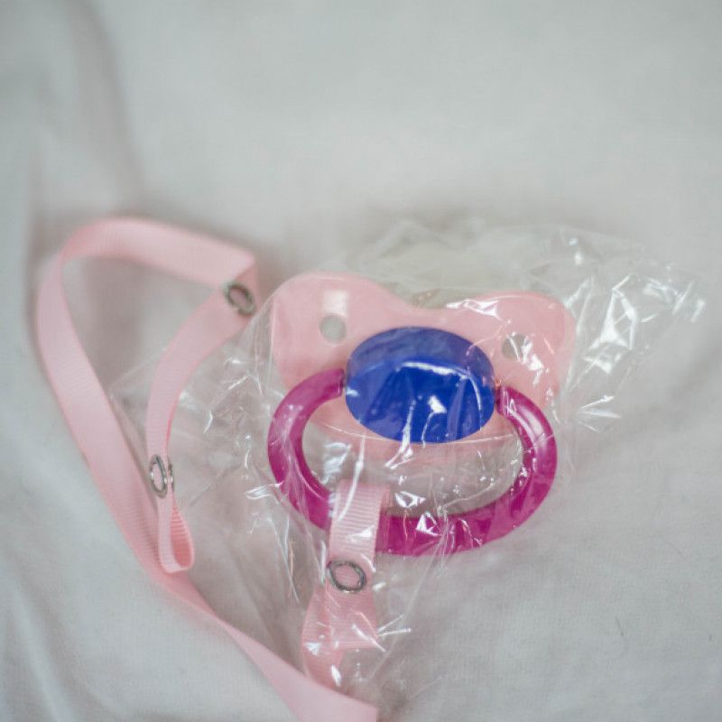 ABDL pacifier with pink ribbon leash