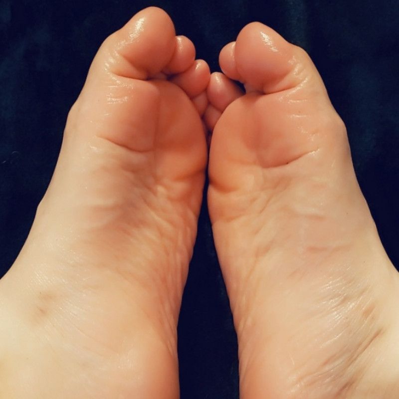 Toes wrapped around a Dildo