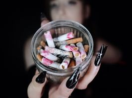 ASHTRAY FULL OF LIPSTICK STAINED CIGARETTE BUTTS