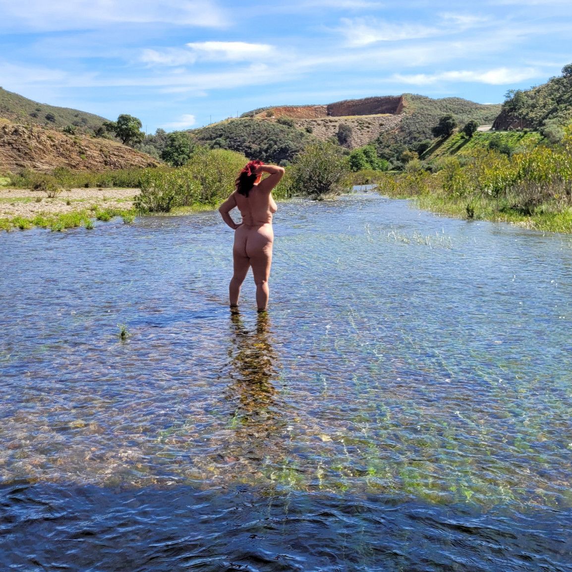 Standing naked in the river