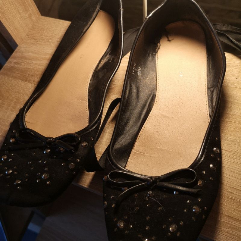 Well worn black ribbon ballet pumps