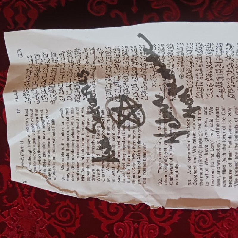 Signed and desecrated Quran page