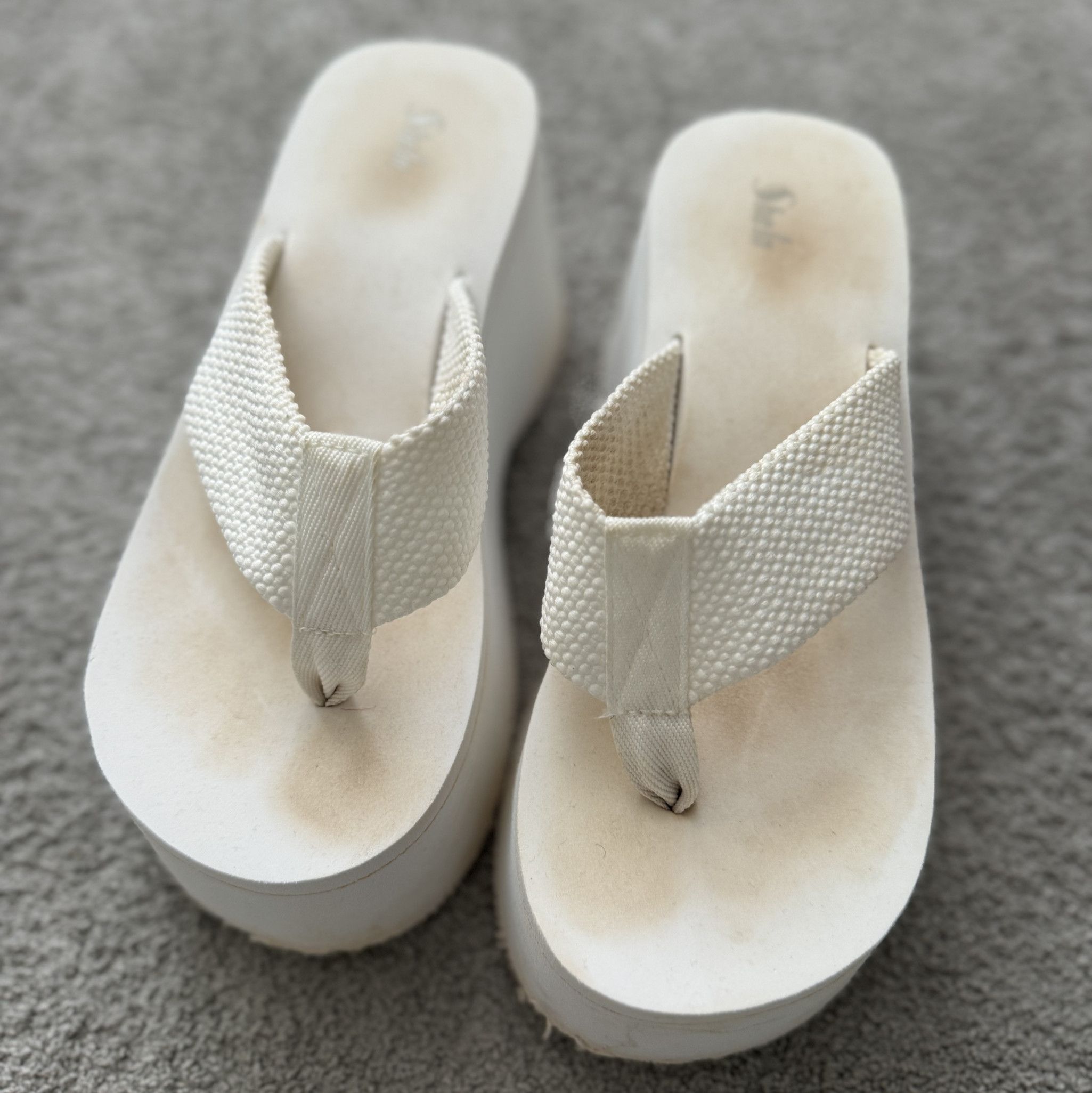 WORN WHITE SLIPPERS