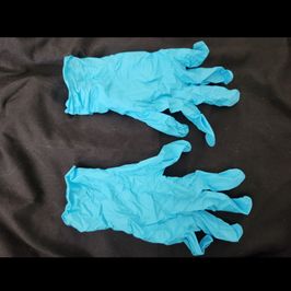 Worn light blue nitrile gloves