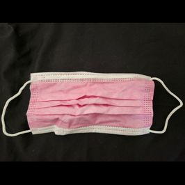 Used pink surgical mask