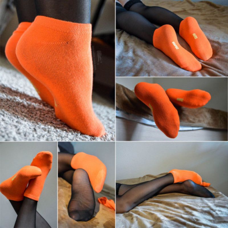 Legs in orange socks and black stockings