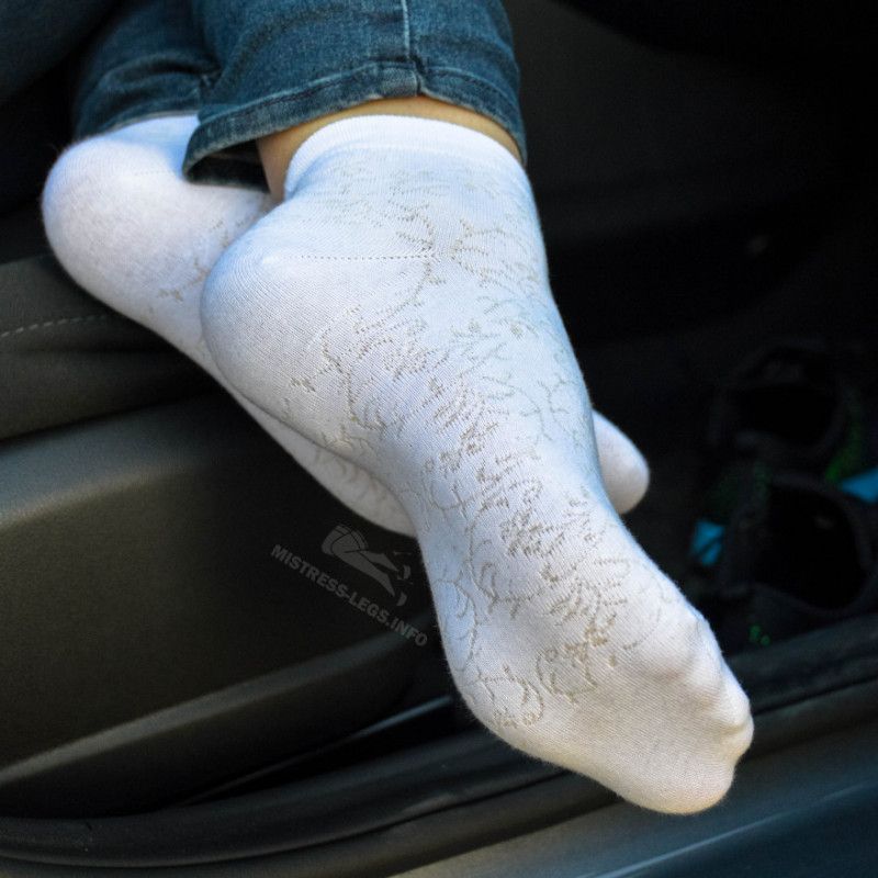 Sexy feet in blue jeans and white socks