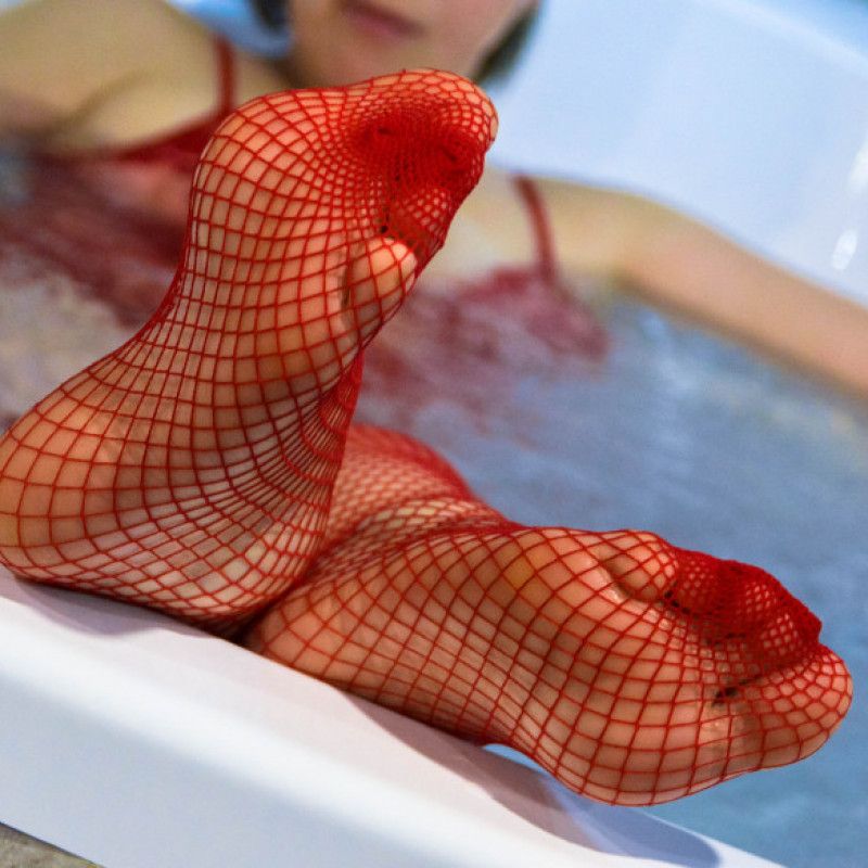 Red fishnet stockings in bath