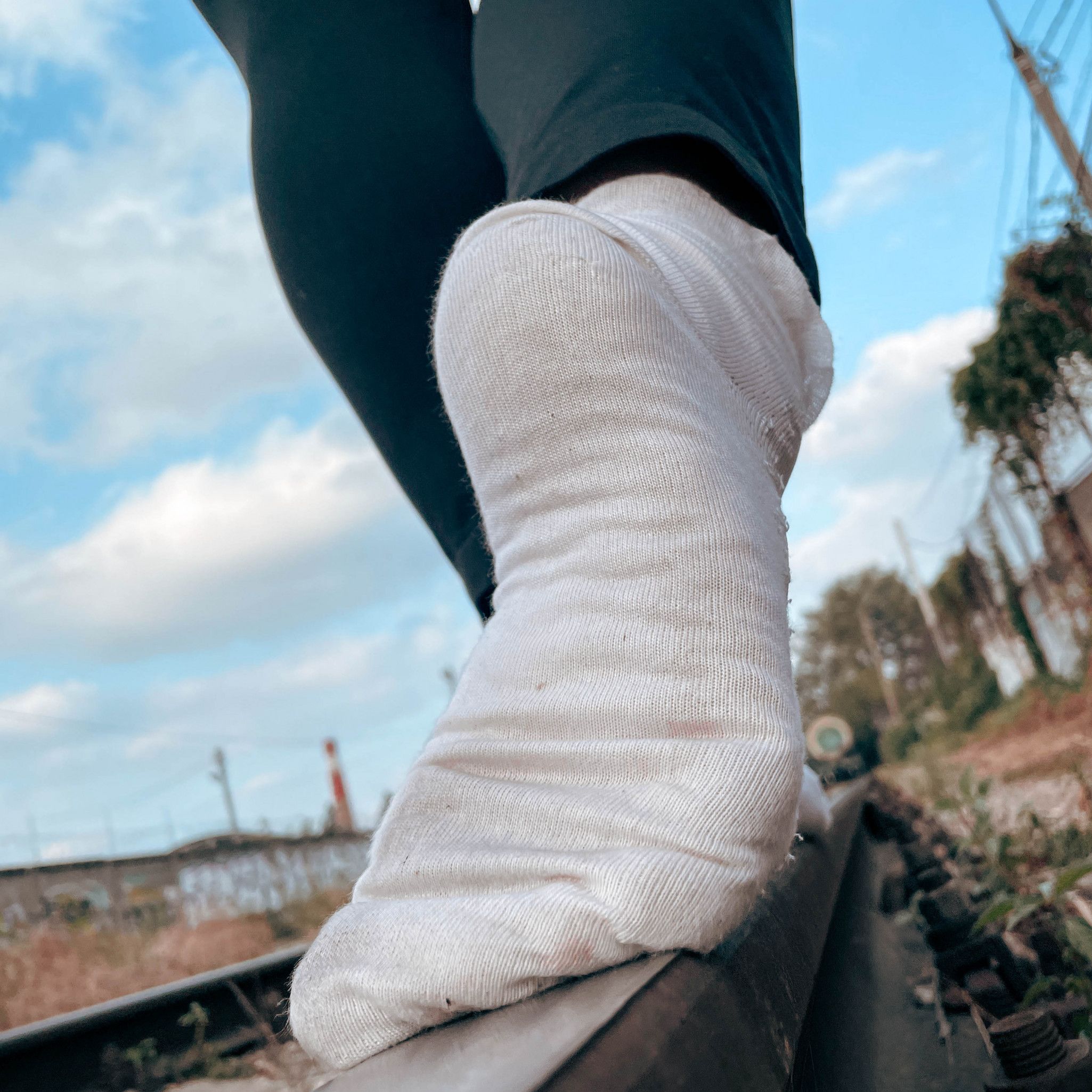 Mistresss legs in black leggings and white socks on a walk