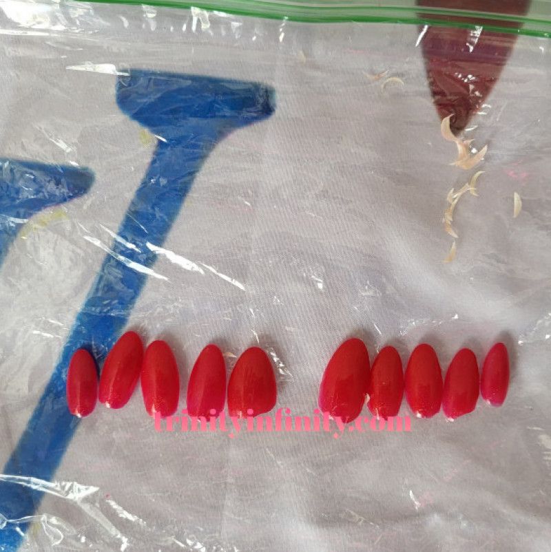 Red Acrylic Nails And Nail Clippings