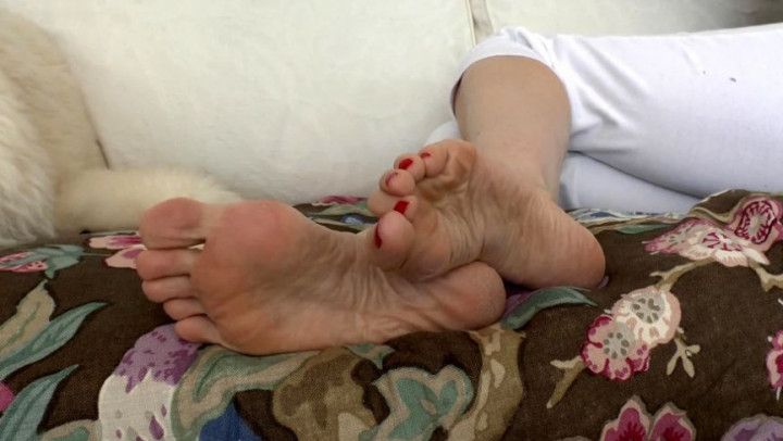 Toes wiggling with red painted toenails