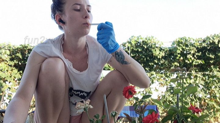 Gardening and smoking Marlboro Red with medical gloves on