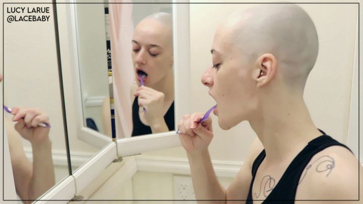 Bald Girl Brushes Her Teeth