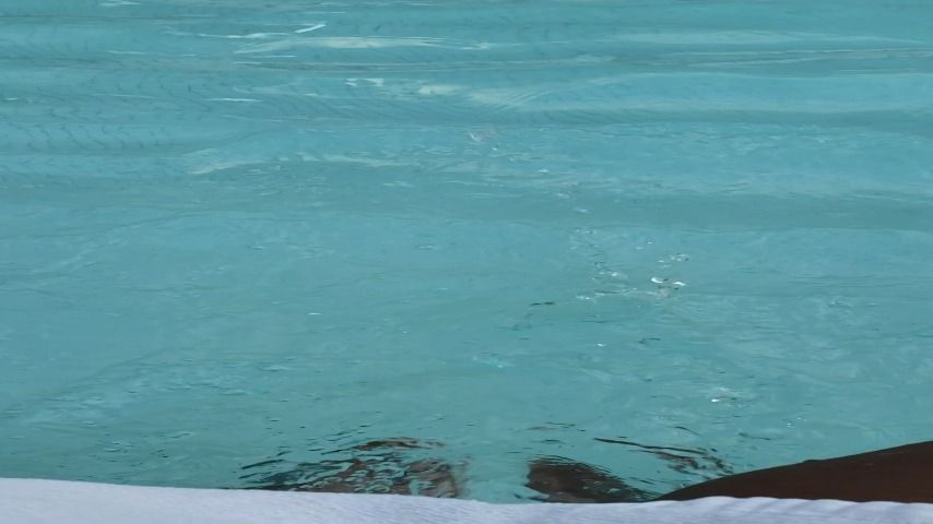 Freshly painted feet playing in the pool