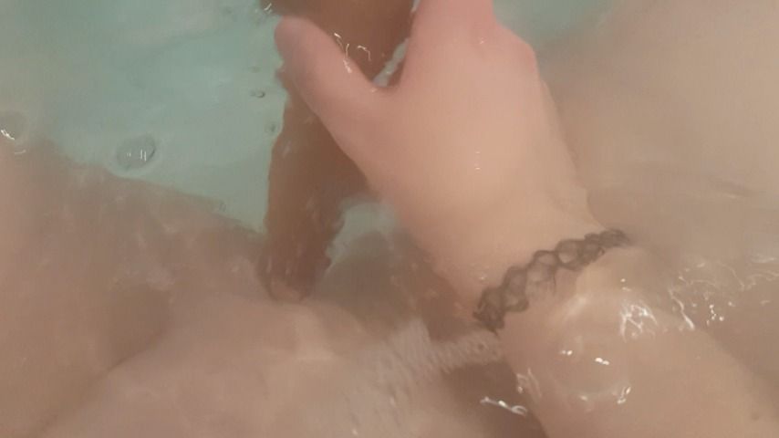 Playing in the bath with a dildo