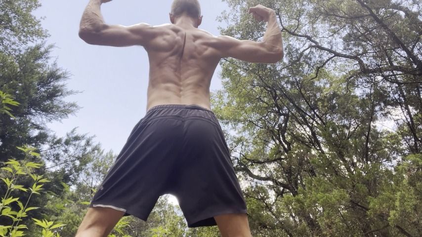 Cam Crest flexes outside in the woods