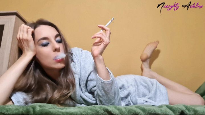 Smoking a cigarette while I relax and lay on my belly