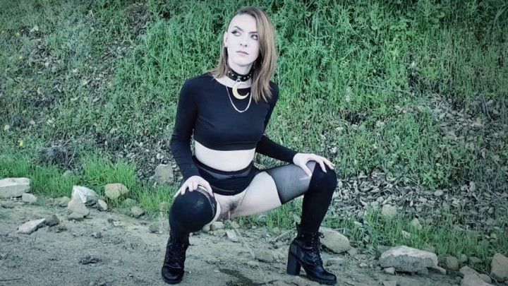 Goth girl pissing on side of the road