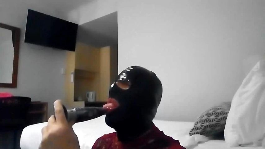 Sucking a Black Dildo In a Latex Hood