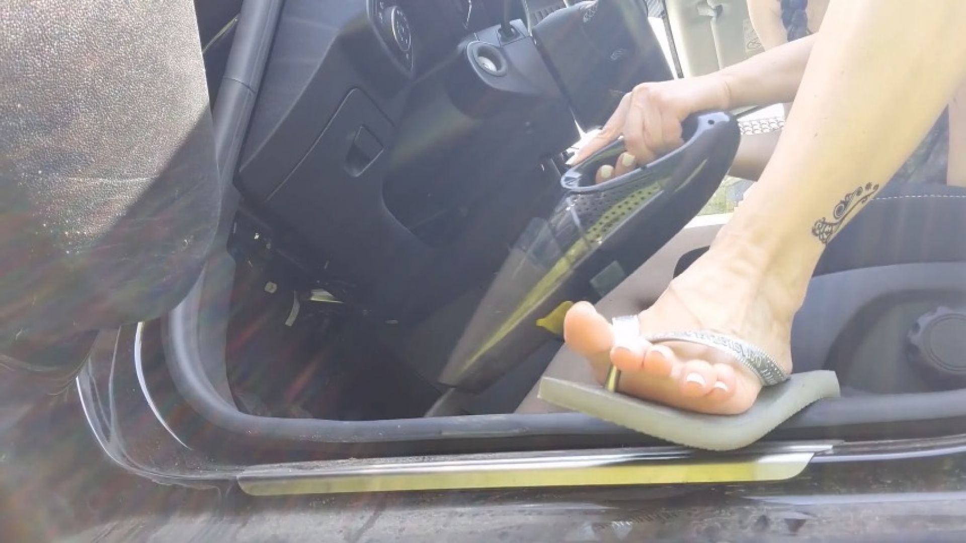 Vacuuming the car in flip-flops