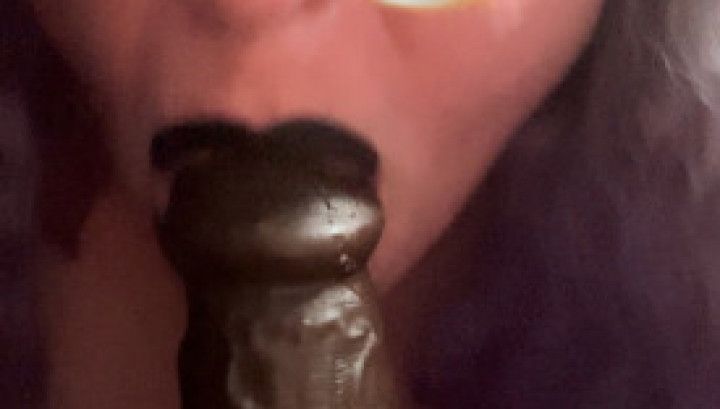 Fellating a big black dildo