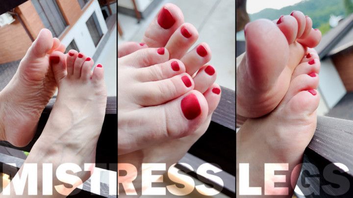 Barefoot with red toenails on the balcony