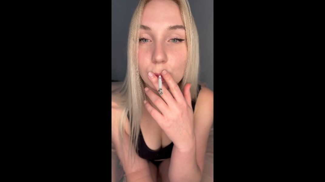 blonde smokes a cigarette