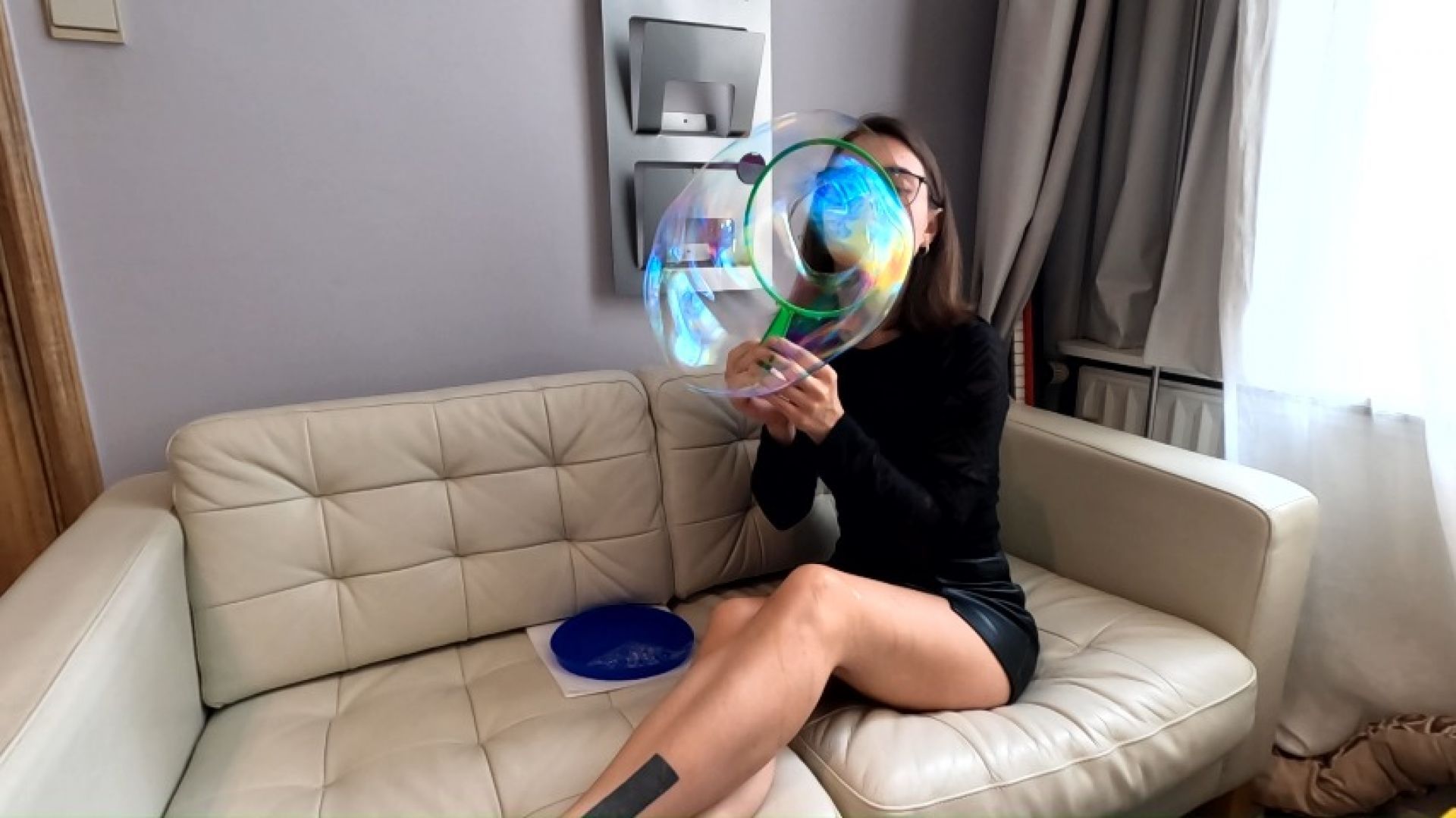 Blowing giant bubbles in a short skirt