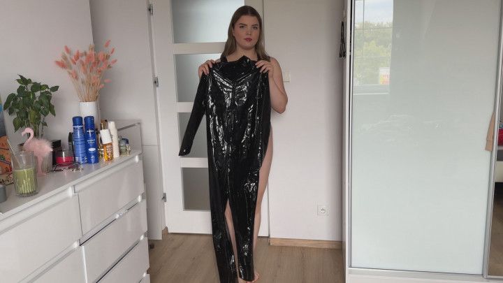 Woman try few pair of leather and pvc catsuits while recordi