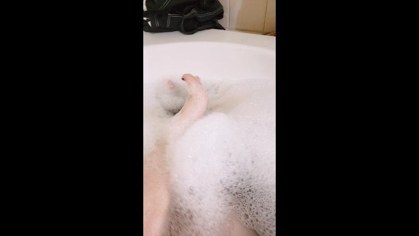 Tattooed and bruised feet bubble bath