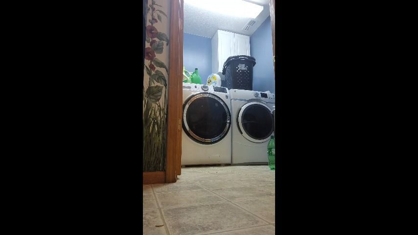 Naked milf doing laundry