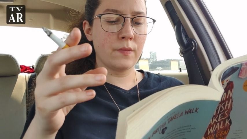 Reading a book and enjoying a smoke