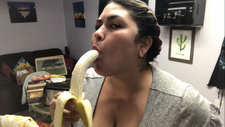 Annie puts a big banana in her mouth