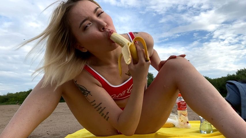 Eating a banana on the beach