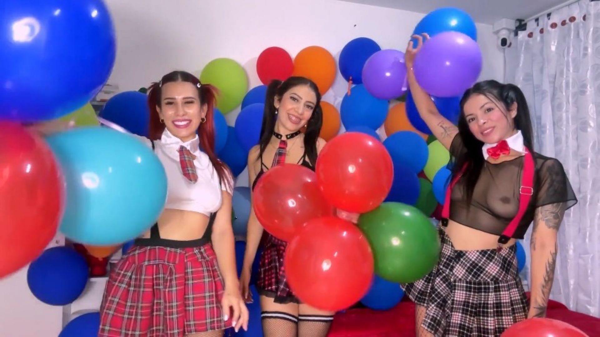 Three schoolgirls having fun with balloons