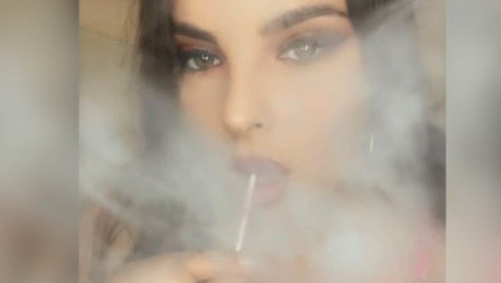 Smoking while sucking a lollipop