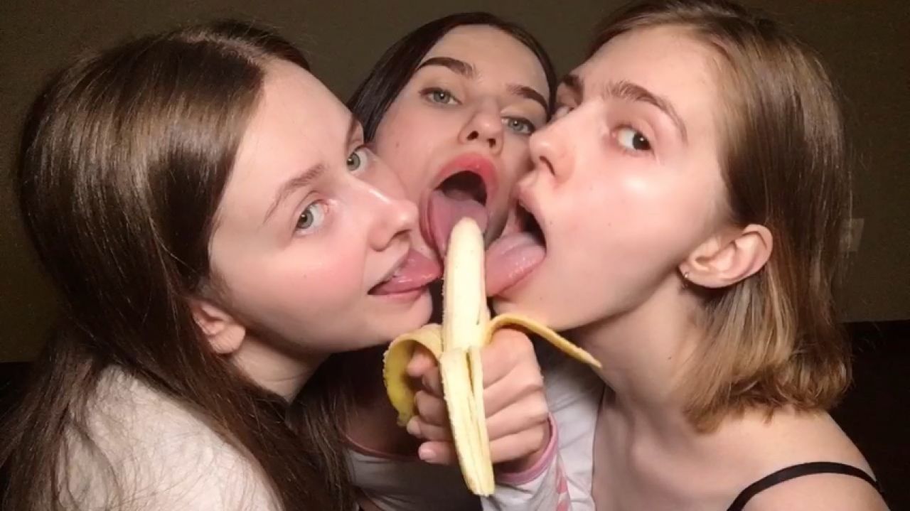 Three girlfriends playing with a banana