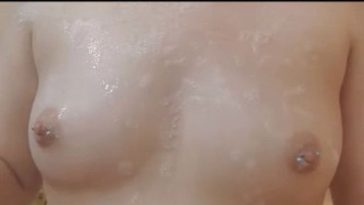 Milf rubs pierced boobs in the bath