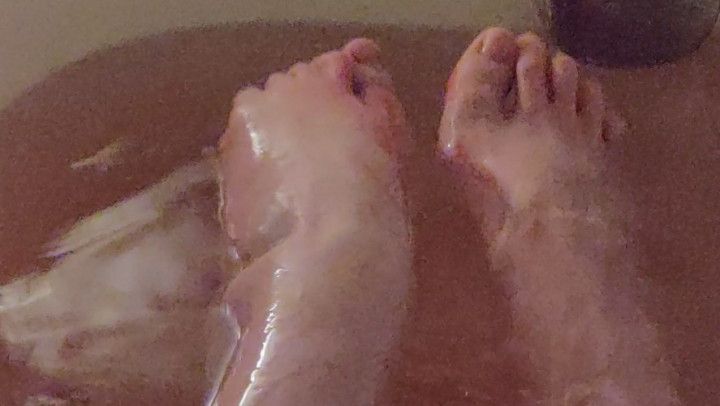 Tiny cute feet plays with bath bomb