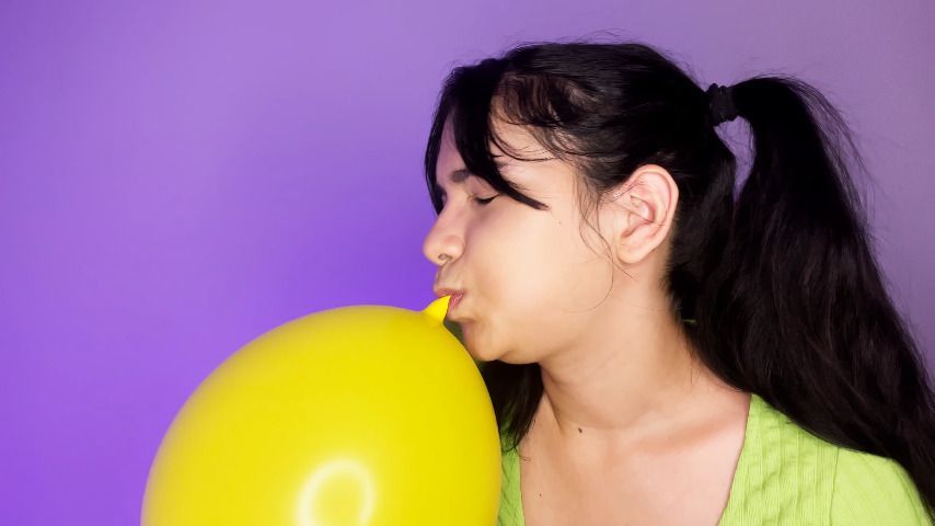 looner girl inflating yellow balloons