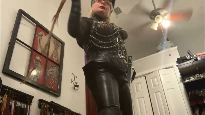 Leather clad Dominatrix whips sissy