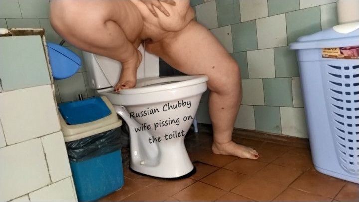 Chubby wife pissing on the toilet