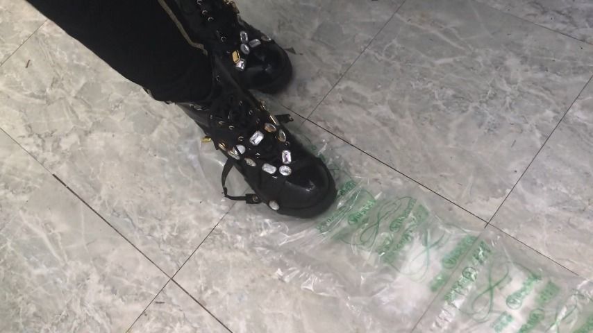 stomping on plastic wrap in sexy boots