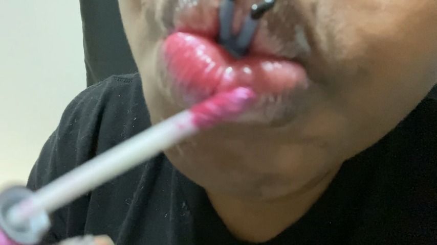 Giantess painting lips with tiny human